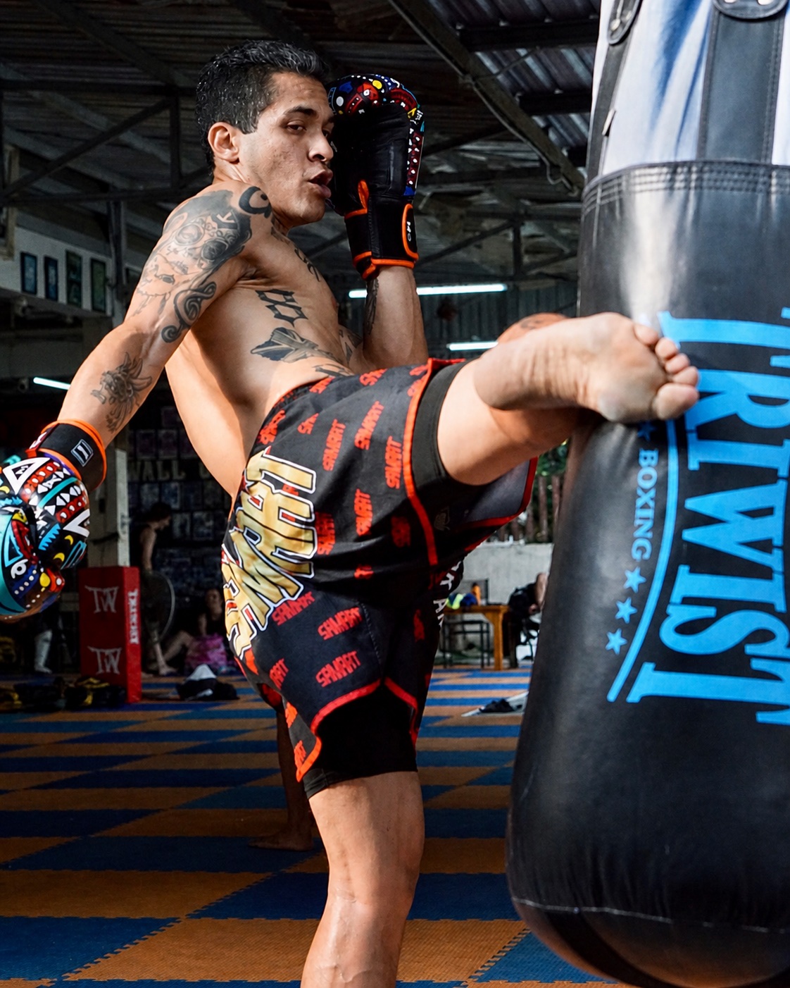 Rob practicing a kick on a heavy bag